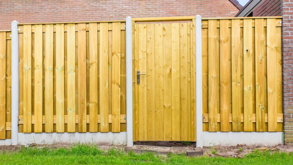 New dutch wooden fence construction with porch and stone wall